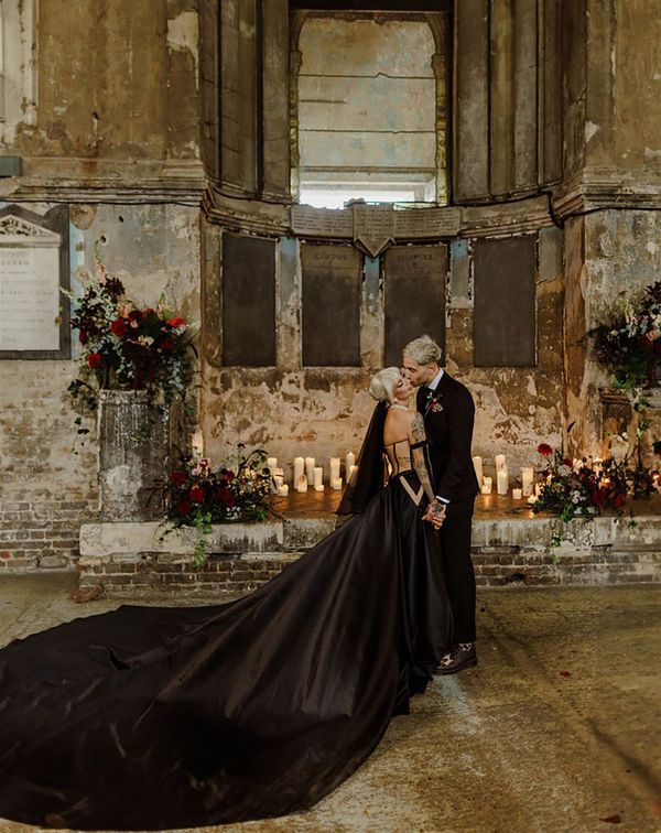 Bride wearing a black wedding dress with long train