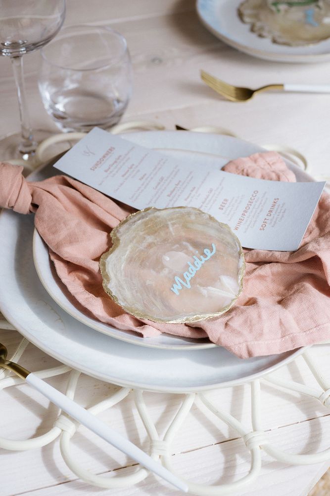 Pink crystal slice place name with pale blue pen doubled up as a wedding favour
