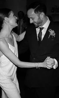 Bride and groom sharing their first dance, smiling in a black-and-white photo – Photographers