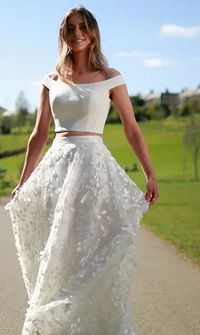 Bride in white bridal separates walking outdoors – Alterations