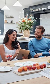 Couple browsing wedding gift options on registry together at home – Gift Lists