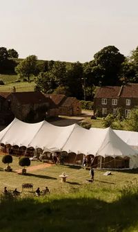 Large white marquee tent set up on a countryside wedding venue – Marquees & Tipis
