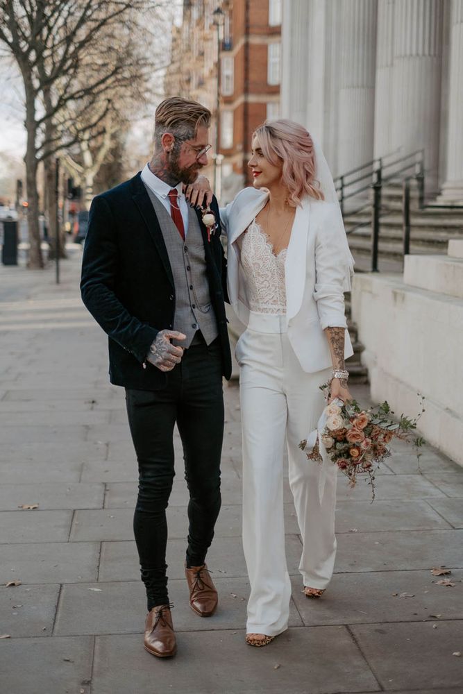 Marylebone wedding with bride in bridal suit complete with lace top beneath 