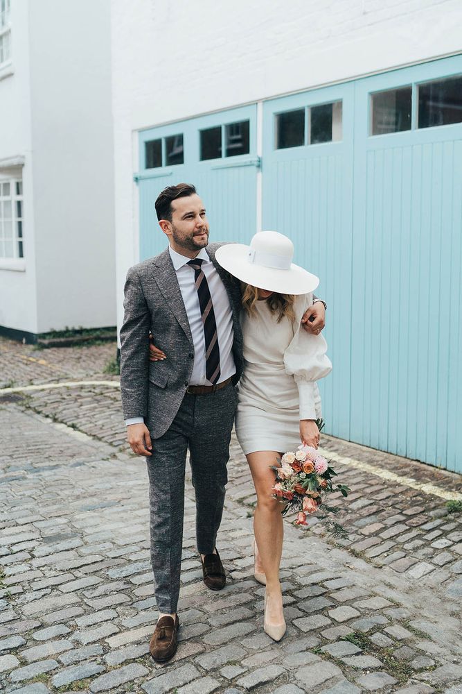 Bride in a short wedding dress from Net a Porter with floppy hat for registry office wedding 