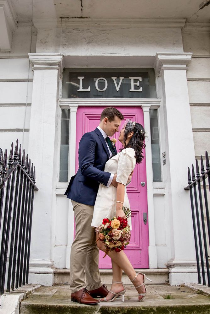 Bride wears short wedding dress complete with polka dot styled Juliet veil 