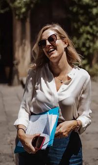 Smiling wedding planner walking outdoors with clipboard – Wedding Planners & Coordinators