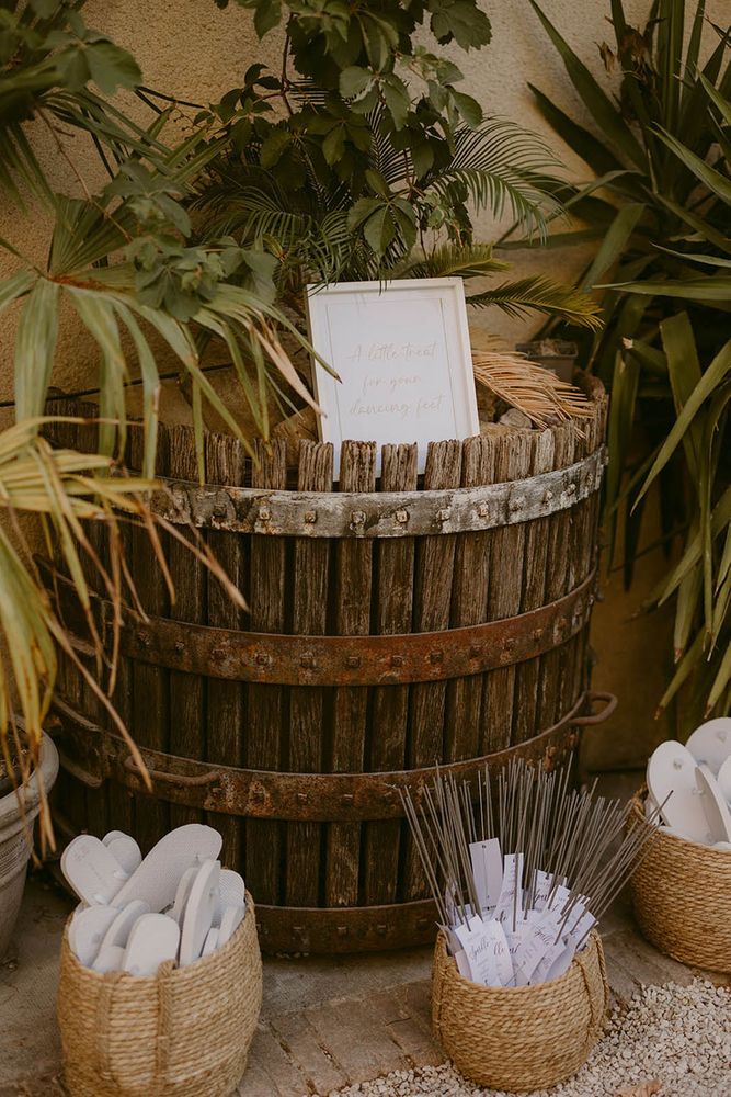 Wedding favours idea with wicker baskets of flip flops and sparklers 