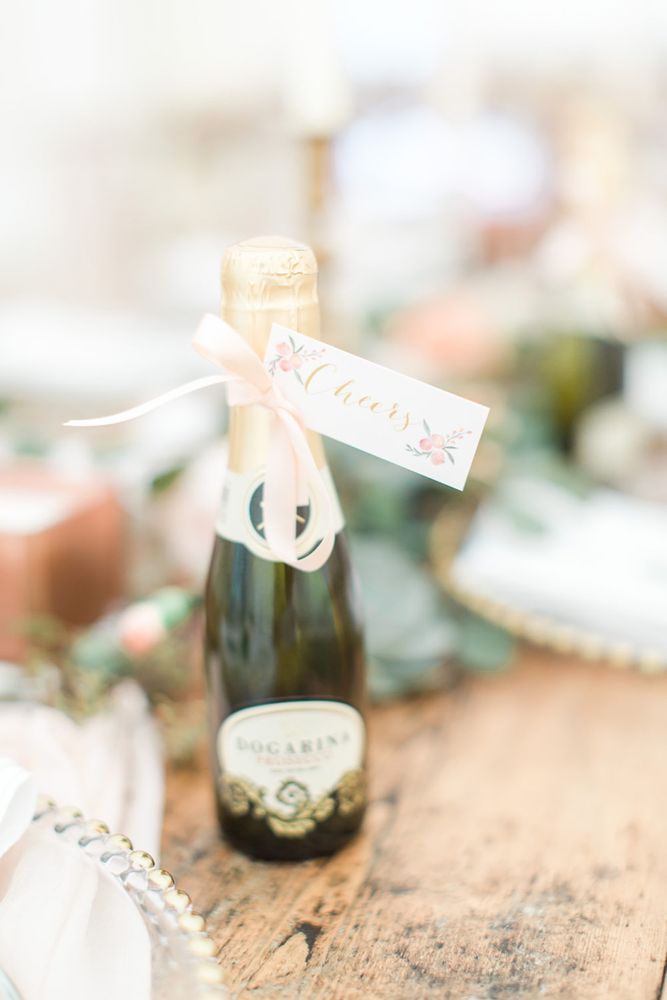 Mini bottle of champagne with pink bow and cheers label 