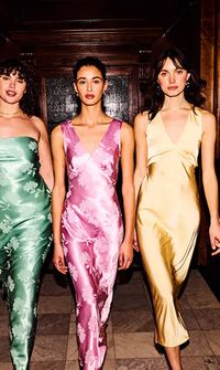 Three bridesmaids in satin coloured dresses walking together – Bridesmaids Dresses