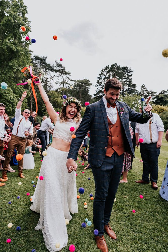 Bride wears tank top styled crop top with embellished full skirt for festival wedding 