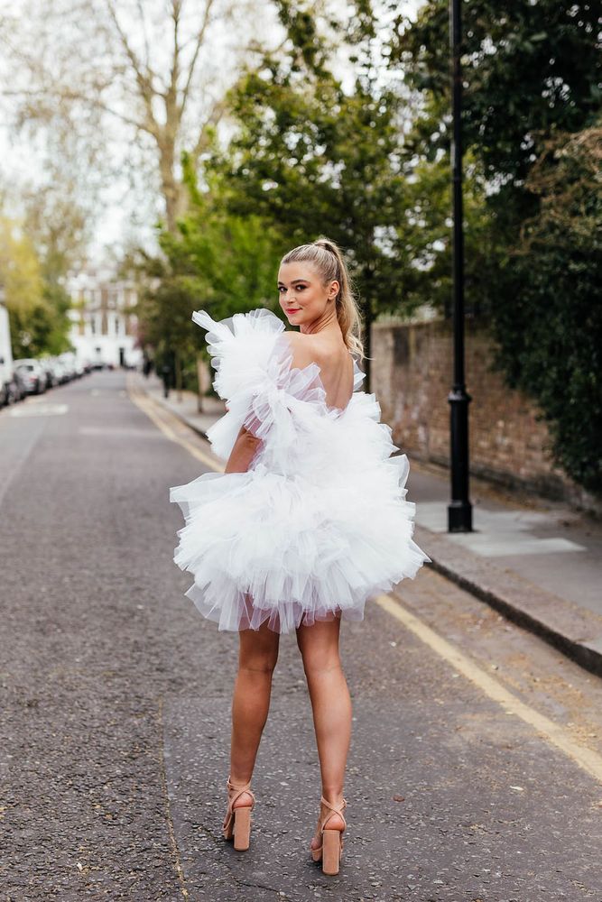 Bride in an extravagant ruffle mini wedding dress 
